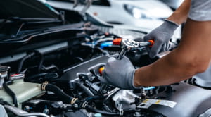 Mechanic working on car engine